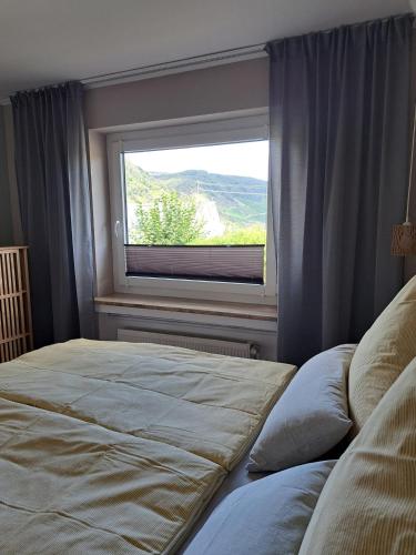 a bedroom with a large bed and a window at Ferienwohnung Wandereck in Boppard