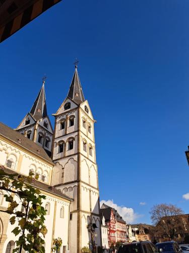 a building with a tower with two spires on it at Ferienwohnung Wandereck in Boppard