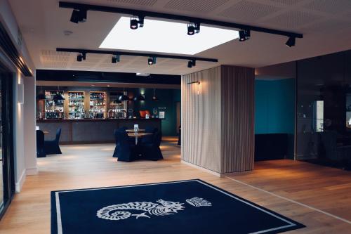 a lobby with a dragon rug on the floor at Royal Ocean Racing Club in West Cowes