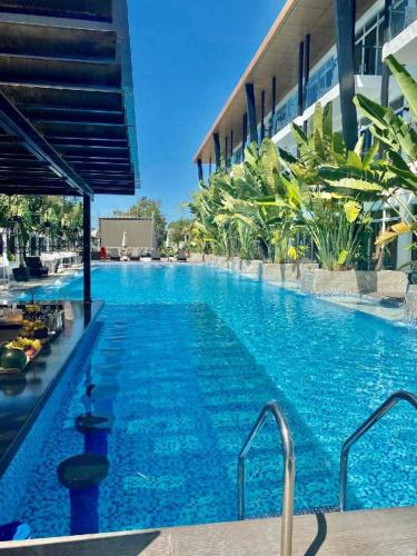 a large blue swimming pool next to a building at The Hotel Sophia in Cauayan City