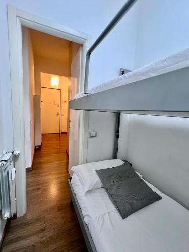 a small white room with a bed in it at CASA MIKI in Rapallo