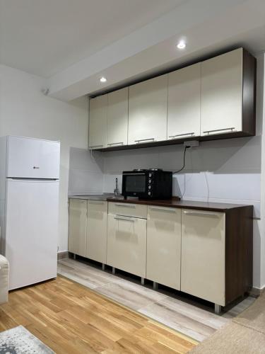 a kitchen with white cabinets and a white refrigerator at Terzibašin Konak in Sarajevo