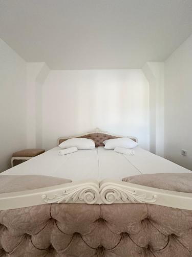 a large white bed with two pillows on it at Terzibašin Konak in Sarajevo