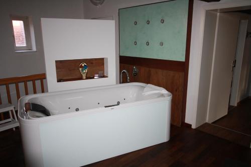 a white bath tub in a room with a sink at Elements Hotel in Regensburg
