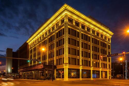 a large building on the corner of a street at night at Curtiss Hotel, an Ascend Collection Hotel in Buffalo