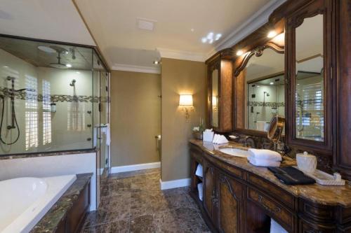 a bathroom with two sinks and a large mirror at Curtiss Hotel, an Ascend Collection Hotel in Buffalo