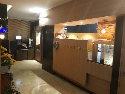 a restaurant with a counter in the middle of a room at SKY Hotel in Changwon
