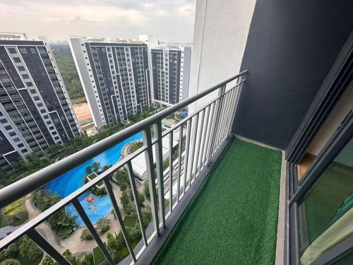 a balcony with green flooring in a building at Mia Casa Maya Bay Splashmania KLIA in Pulau Kempas