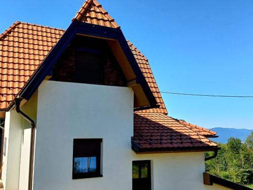 a white house with a red roof at TARA Vila Rajak in Zaovine