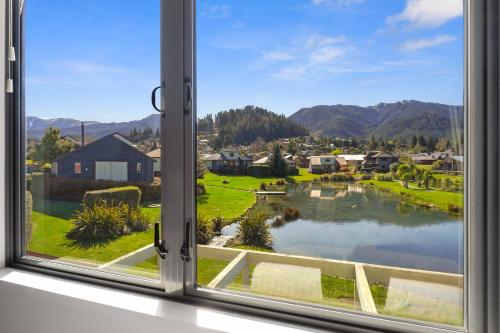 a window with a view of a town at *** LAKE VILLA 458 *** in Hanmer Springs