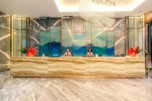 two women in a reception desk in a hotel lobby at Guilin Manhatton Hotel Tianjie in Guilin