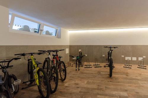 a man standing in a room with several bikes at Mason La Zondra in Vigo di Fassa