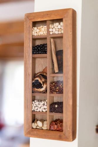 a wooden cabinet filled with different types of rocks at Luxury House on Seafront in Curryglass