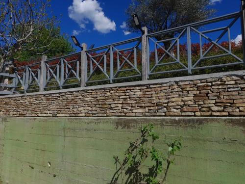 a fence on top of a stone wall at CASA DEL CANTA in Borgomale