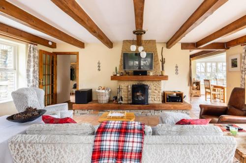 a living room with two couches and a fireplace at Luxury House on Seafront in Curryglass