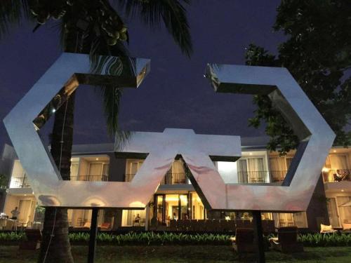 a building with a statue in front of it at night at Double G Resort Anyer in Carita