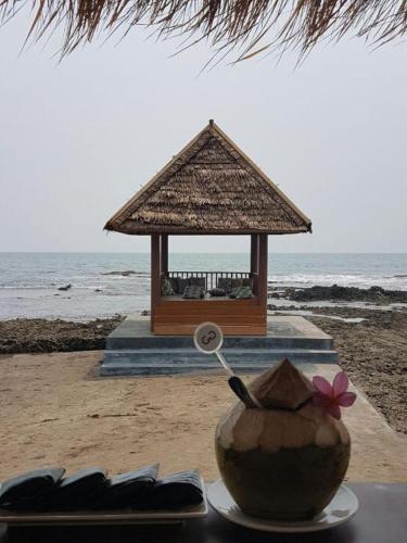 a bowl on a table next to a gazebo on the beach at Double G Resort Anyer in Carita