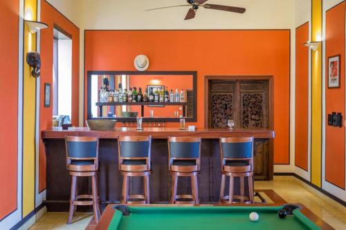 a bar with a pool table in a room at Le Relais de Chhlong in Kratie