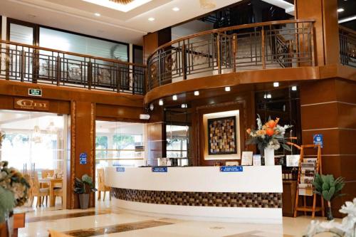 a lobby of a restaurant with a counter and balconies at Subic Grand Harbour Hotel Subic Bay in Olongapo
