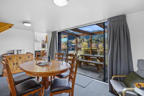 a kitchen and living room with a table and chairs at *** LAKE VILLA 465 *** in Hanmer Springs