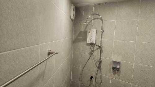a bathroom with a shower with a shower head at Neighbor Hostel in Haad Rin