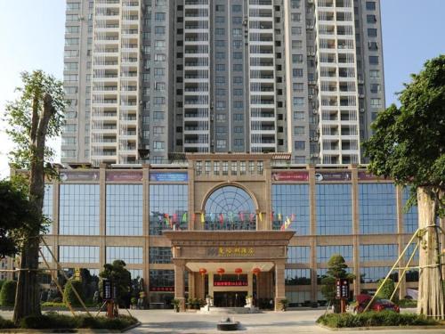 a building in front of some tall buildings at Manhatton Hotel Beihai in Beihai