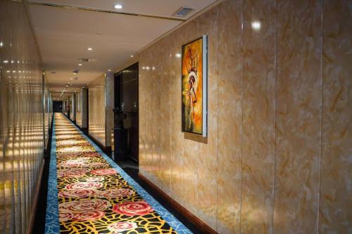 a hallway with a carpet on the floor in a building at Manhatton Hotel Beihai in Beihai