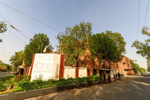 a sign for a hotel on the side of a street at Hotel One Faisalabad in Faisalabad