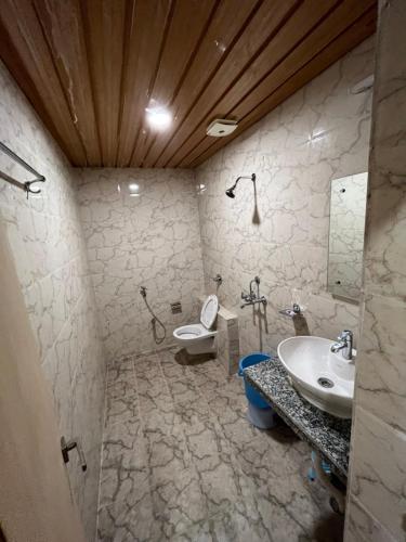 a bathroom with a sink and a toilet at Hotel Pratap Heights in Rānchī