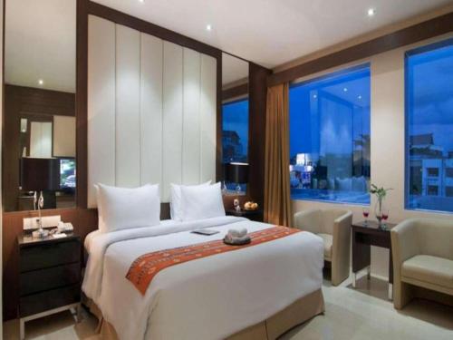 Кровать или кровати в номере Aria Barito Hotel