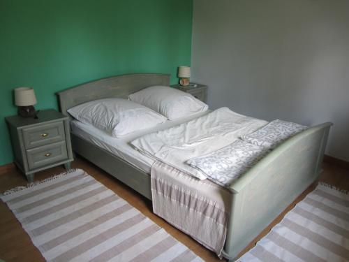 a bedroom with a bed with two night stands at Willa w Ogrodzie in Sandomierz