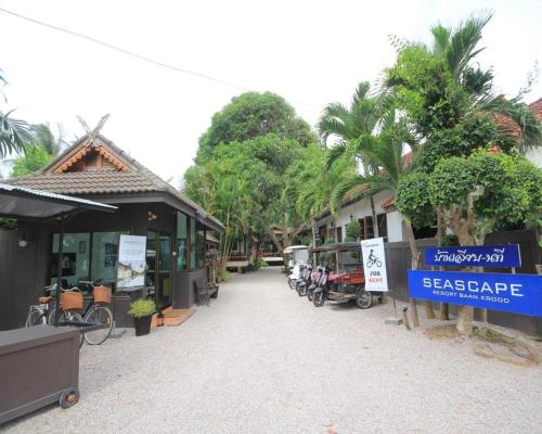 a street with some buildings and trees and a sign at Seascape Resort Baan Krood in Ban Krut