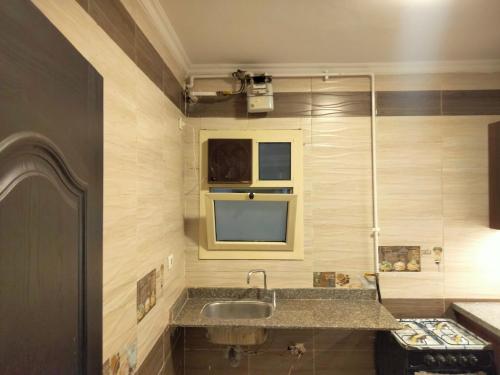 a bathroom with a sink and a shower at Cozy G Apartment with Garden View - 2 Beds in Dar Misr Compound, Sheikh Zayed in Sheikh Zayed