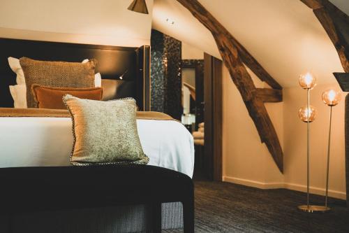 a bedroom with a large bed and a mirror at Château de Maraval in Cénac-et-Saint-Julien
