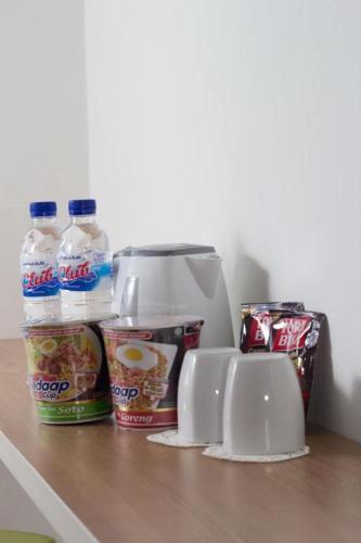 a refrigerator with some drinks and snacks on a counter at Sakura Manado in Manado