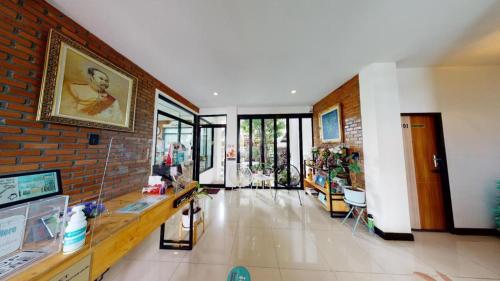 a large room with a brick wall and a store at The Connect Chiang Mai in Chiang Mai