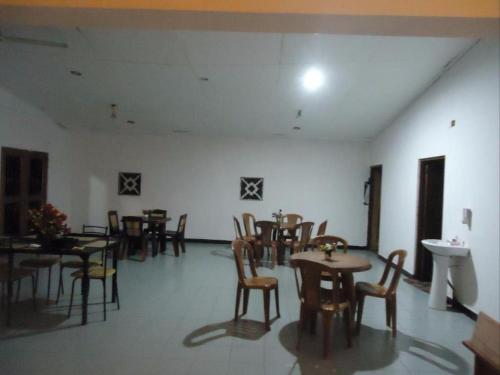 a dining room with tables and chairs in a room at Seven Flowers Hotel in Anuradhapura