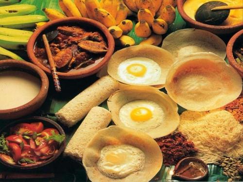a table topped with eggs and other food items at Lagoon Beach Resort in Tangalle