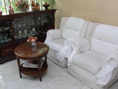 a living room with a couch and a coffee table at Ratu Hotel Serang in Serang
