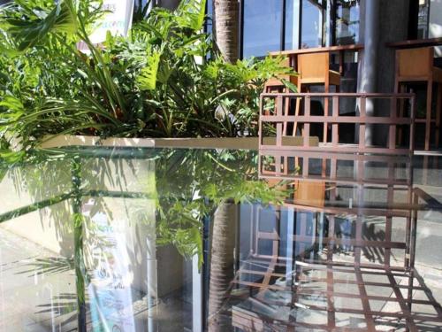 a table with a bunch of plants in a room at Ratu Hotel Serang in Serang