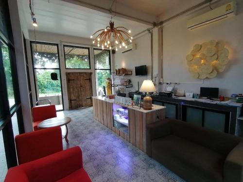 a living room with a kitchen with a table and chairs at Villa Gris Pranburi in Pran Buri