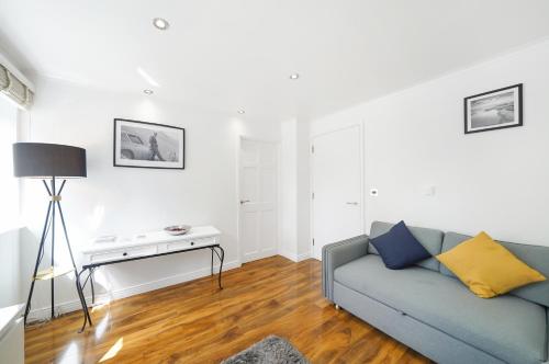 a living room with a couch and a table at A beautiful stylish 2 Bedroom Apartment -City of London in London