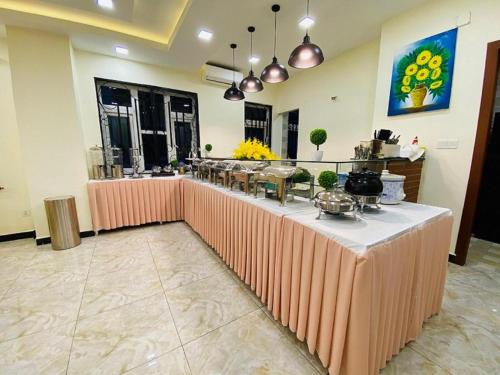 a long table in a room with a buffet at ICON Hotel in Phnom Penh