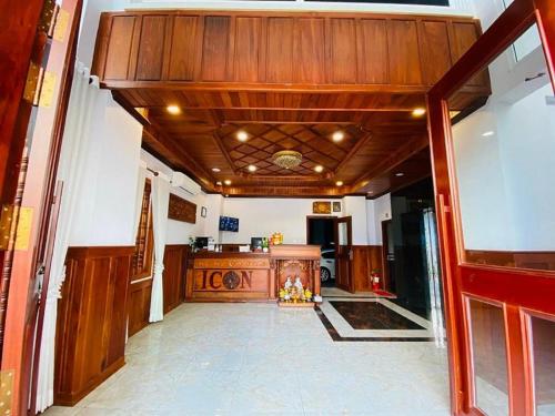 a large hallway with a wood ceiling and a desk at ICON Hotel in Phnom Penh