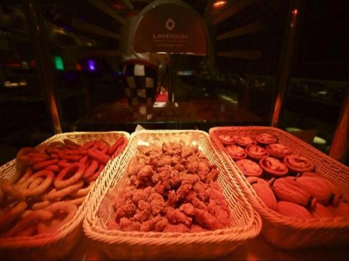 three baskets filled with different types of food on a table at Weida Hotel Jinhua in Jinhua