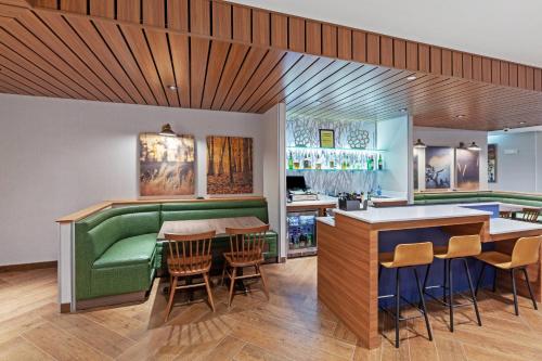 a bar with a green couch in a restaurant at Fairfield Inn & Suites by Marriott Liberal in Liberal