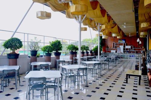 a row of tables and chairs in a restaurant at Grant Hotel Subang in Bandung