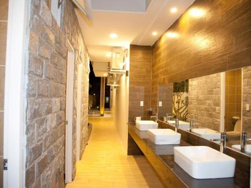 a bathroom with three sinks and a row of mirrors at Seaview Long Hai Hotel in Long Hai