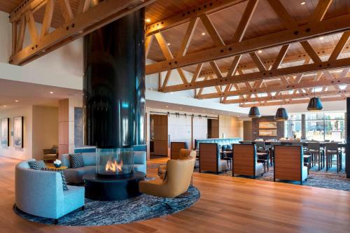 a lobby with a fireplace and a dining area at Residence Inn by Marriott Redwood City San Carlos in San Carlos