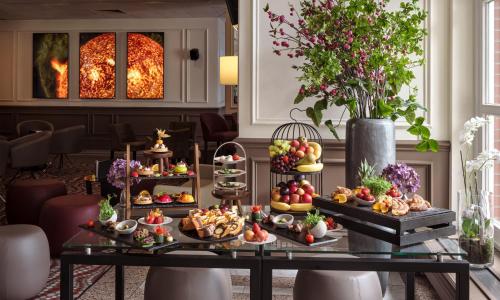 a buffet of food on a table in a room at Leonardo Hotel Hamburg Stillhorn in Hamburg